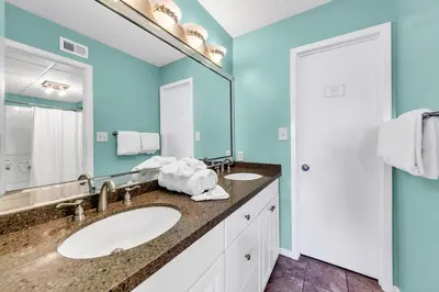 a bathroom with two sinks and a large mirror at Edgewater Golf Villa 3101 in Panama City Beach