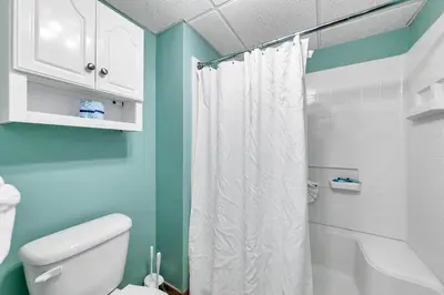 a bathroom with a white toilet and blue walls at Edgewater Golf Villa 3101 in Panama City Beach