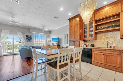 a kitchen and dining room with a table and chairs at The Palms A3 in Panama City Beach