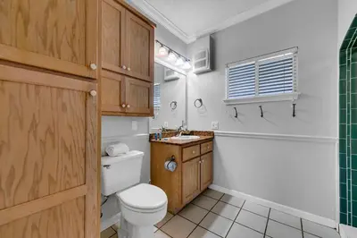 a bathroom with a toilet and a sink and a tub at The Palms A3 in Panama City Beach