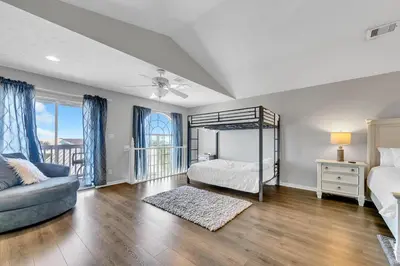a bedroom with a bed and a couch at The Palms A3 in Panama City Beach