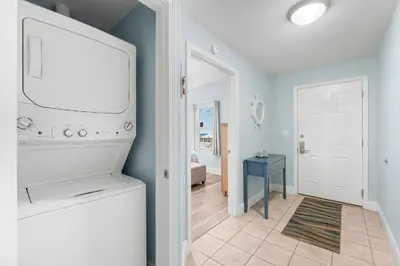 a living room with a flat screen tv and a hallway at Laketown Wharf #0414 in Panama City Beach