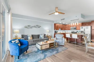 a living room with a couch and chairs and a kitchen at Laketown Wharf #0414 in Panama City Beach
