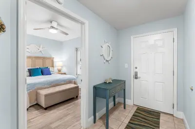a bedroom with a bed and a blue table at Laketown Wharf #0414 in Panama City Beach