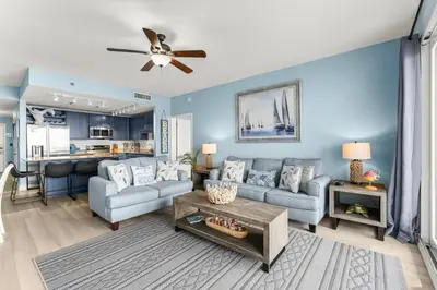 a living room with a couch and a table at Laketown Wharf #1407 in Panama City Beach