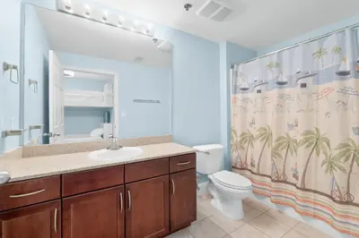 a bathroom with a sink and a toilet and a shower curtain at Laketown Wharf #0804 in Panama City Beach