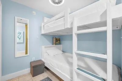 a white bunk bed in a room with blue walls at Laketown Wharf #0804 in Panama City Beach