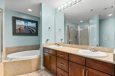 a bathroom with two sinks and a shower at Laketown Wharf #1931 in Panama City Beach