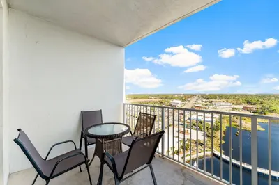 a balcony with chairs and a table with a view at Laketown Wharf #1931 in Panama City Beach