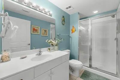 a bathroom with a shower and a sink and a toilet at Celadon #2106 in Panama City Beach