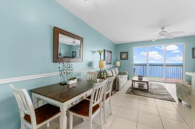 a dining room with a table and a view of the ocean at Celadon #2106 in Panama City Beach