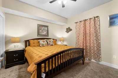 a bedroom with a crib in a room with a window at Celadon #2106 in Panama City Beach