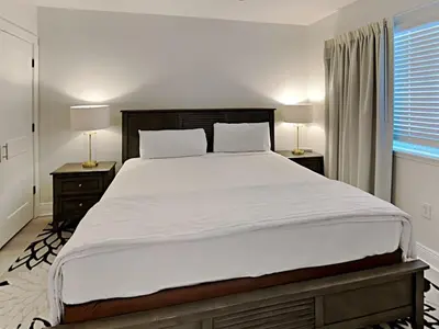 a bedroom with a large white bed with two lamps at Emerald Beach #1032 in Panama City Beach