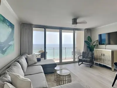 a living room with a couch and a television at Emerald Beach #1032 in Panama City Beach