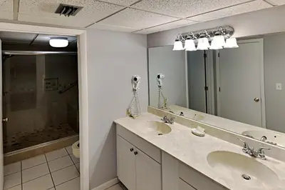a bathroom with two sinks and a large mirror at Edgewater Tower I #111 in Panama City Beach