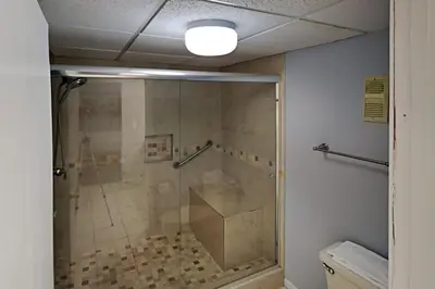 a shower with a glass door in a bathroom at Edgewater Tower I #111 in Panama City Beach