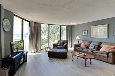 a living room with a couch and a tv at Edgewater Tower I #111 in Panama City Beach