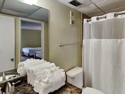 a bathroom with a shower and a toilet and a mirror at Edgewater Tower II #209 in Panama City Beach
