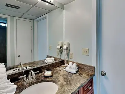a bathroom with a sink and a large mirror at Edgewater Tower II #209 in Panama City Beach