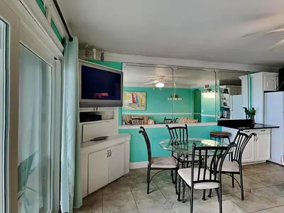 a dining room with a table and chairs at Summit Beach Resort #222 in Panama City Beach