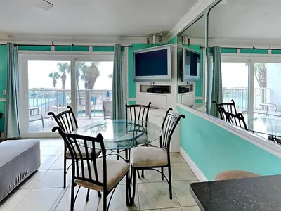a dining room with a glass table and chairs at Summit Beach Resort #222 in Panama City Beach