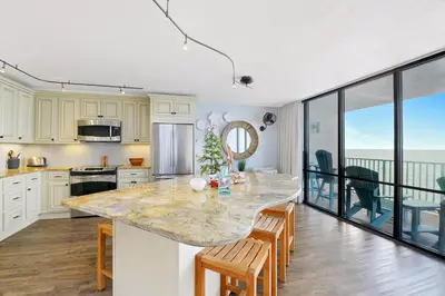 a kitchen with a large island with a counter top at Edgewater Leeward #307 in Panama City Beach