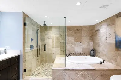 a large bathroom with a tub and a shower at Edgewater Leeward #307 in Panama City Beach