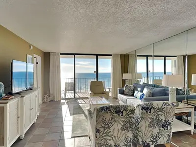a living room with a couch and a tv at Edgewater Tower III #604 in Panama City Beach