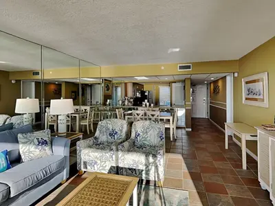 a living room with a couch and chairs and a table at Edgewater Tower III #604 in Panama City Beach