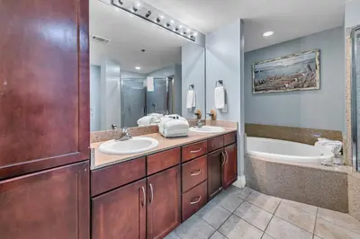 a bathroom with two sinks and a tub at Laketown Wharf 1523 by Emerald Coast Retreats in Panama City Beach