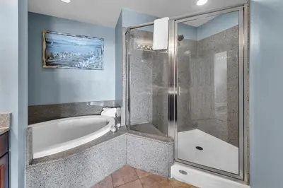 a bathroom with a bath tub and a shower at Laketown Wharf 1523 by Emerald Coast Retreats in Panama City Beach