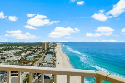 a view of the beach from the balcony of a resort at Treasure Island #1401 in Panama City Beach
