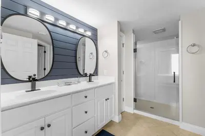 a bathroom with two sinks and a large mirror at Treasure Island #1401 in Panama City Beach