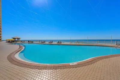 a large swimming pool next to the beach at Treasure Island #0101 in Panama City Beach