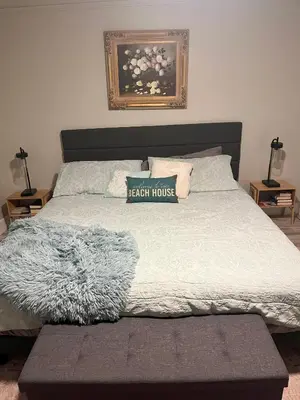 a bedroom with a bed with a black house sign on it at 2 bedroom duplex in Panama City Beach Florida -upstairs unit in Panama City Beach