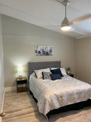 a bedroom with a bed and a ceiling fan at 2 bedroom duplex in Panama City Beach Florida -upstairs unit in Panama City Beach
