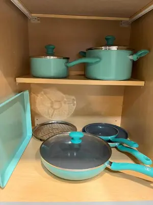 a frying pan and two pots and pans on a shelf at 2 bedroom duplex in Panama City Beach Florida -upstairs unit in Panama City Beach