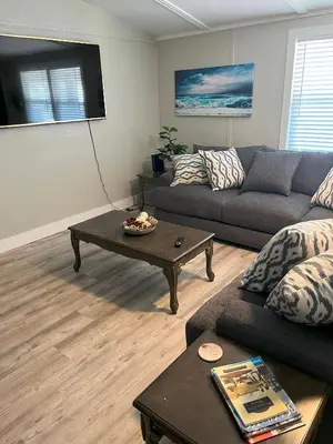 a living room with a couch and a coffee table at 2 bedroom duplex in Panama City Beach Florida -upstairs unit in Panama City Beach