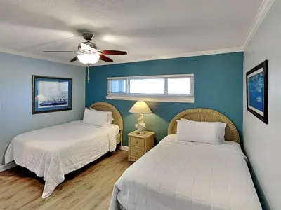 a bedroom with two beds and a ceiling fan at Moonspinner 415A in Panama City Beach