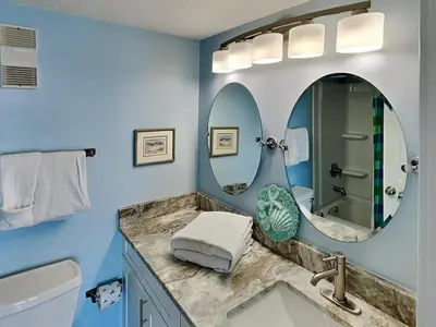 a bathroom with a sink and a mirror at Moonspinner 415A in Panama City Beach