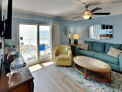 a living room with a couch and a table at Moonspinner 415A in Panama City Beach
