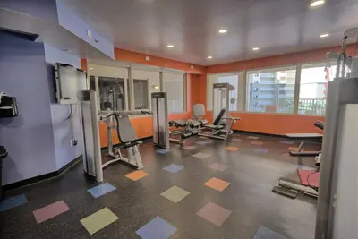 a gym with several exercise equipment in a room at Pineapple Paradise, Beach Front, Newly Renovated, Sleeps 6 in Panama City Beach