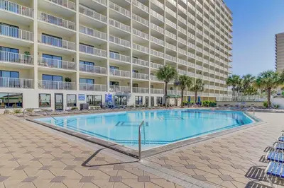 a swimming pool in front of a large apartment building at The Summit 431 in Panama City Beach