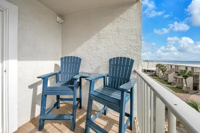 two blue chairs sitting on a balcony at The Summit 431 in Panama City Beach