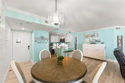 a kitchen and dining room with a table and chairs at Sunbird 107E by InJoy Vacations in Panama City Beach