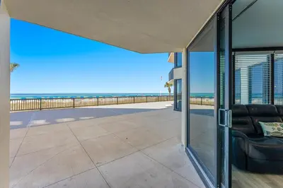 a view of the beach from the balcony of a house at Sunbird 107E by InJoy Vacations in Panama City Beach