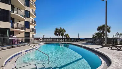 a swimming pool in front of a apartment building at Sunbird 107E by InJoy Vacations in Panama City Beach