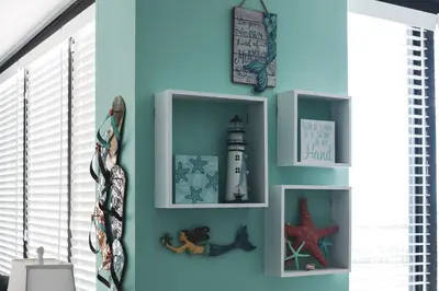 a room with a blue wall with shelves at Sunbird 107E by InJoy Vacations in Panama City Beach