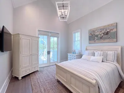 a bedroom with a large bed and a tv at Watersound 13 - Hosted by Top Villas in Watersound Beach