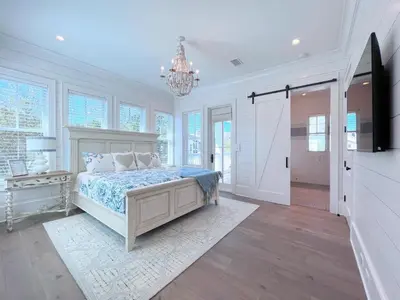 a bedroom with a bed and a chandelier at Watersound 13 - Hosted by Top Villas in Watersound Beach